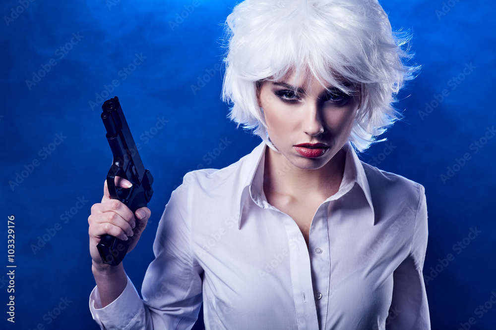 beautiful sexy girl holding gun . smoke background beautiful sexy girl holding gun . smoke background