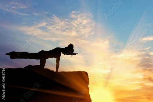 Fototapeta Naklejka Na Ścianę i Meble -  Silhouette of a girl practicing yoga