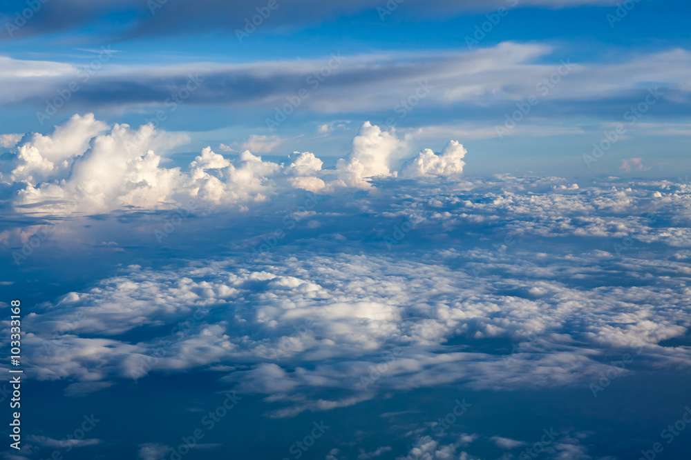 Clouds and sky as seen through window of an aircraft Clouds and sky as seen through window of an aircraft