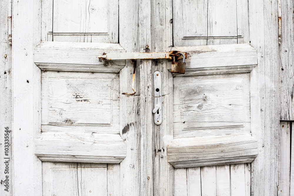 part of the old locked wooden door painted in white