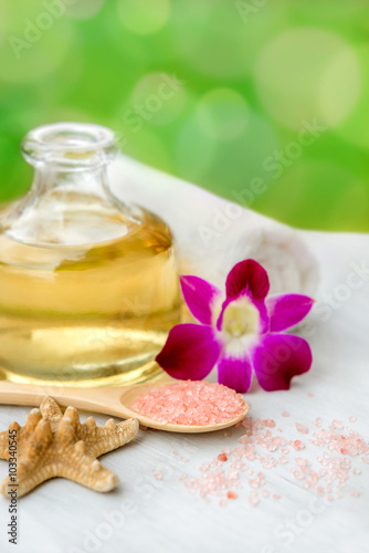 Spa and wellness setting with sea salt  oil essence  flowers and