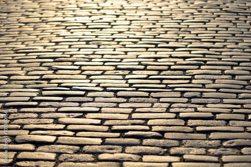 Cobblestones shining in yel...