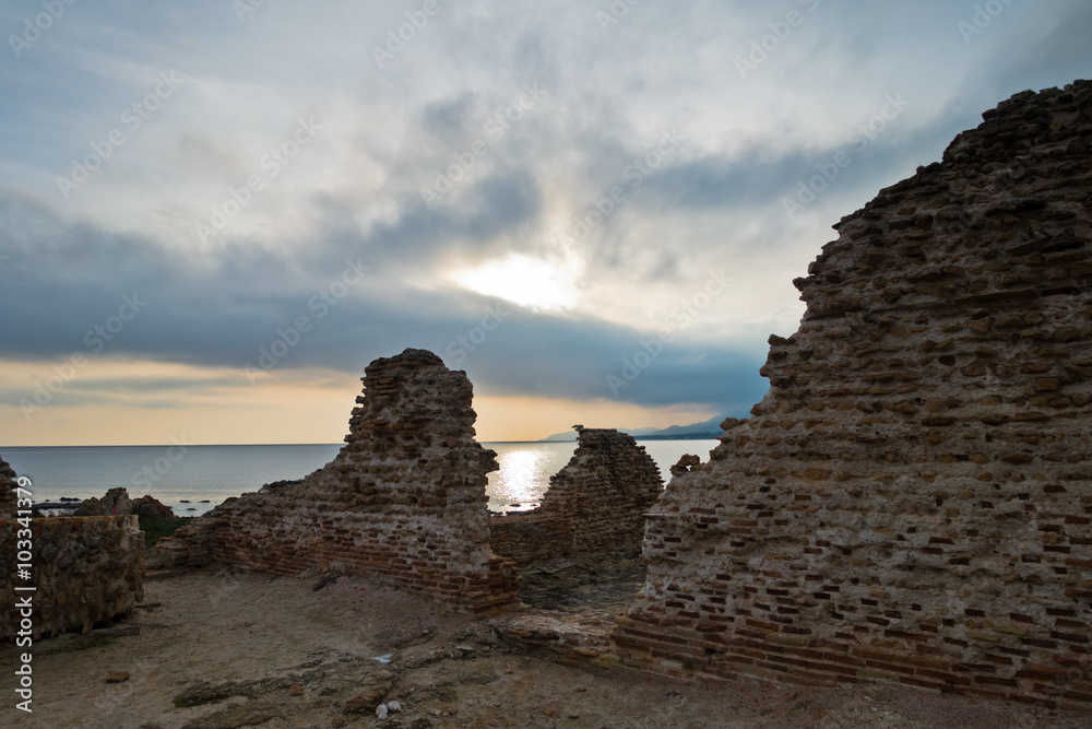 Beach with ruins of old roman city of Nora, Sardinia, Italy