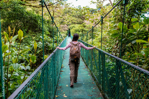 Girl on hanging bridge in cloudforest - Monteverde, Costa Rica photo