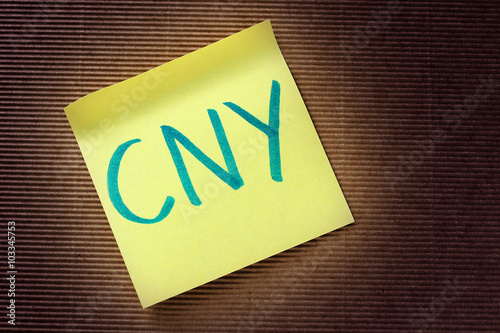 CNY (Chinese Yuan) acronym on yellow sticky note