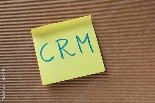 CRM text (Customer relationship management) on yellow sticky not