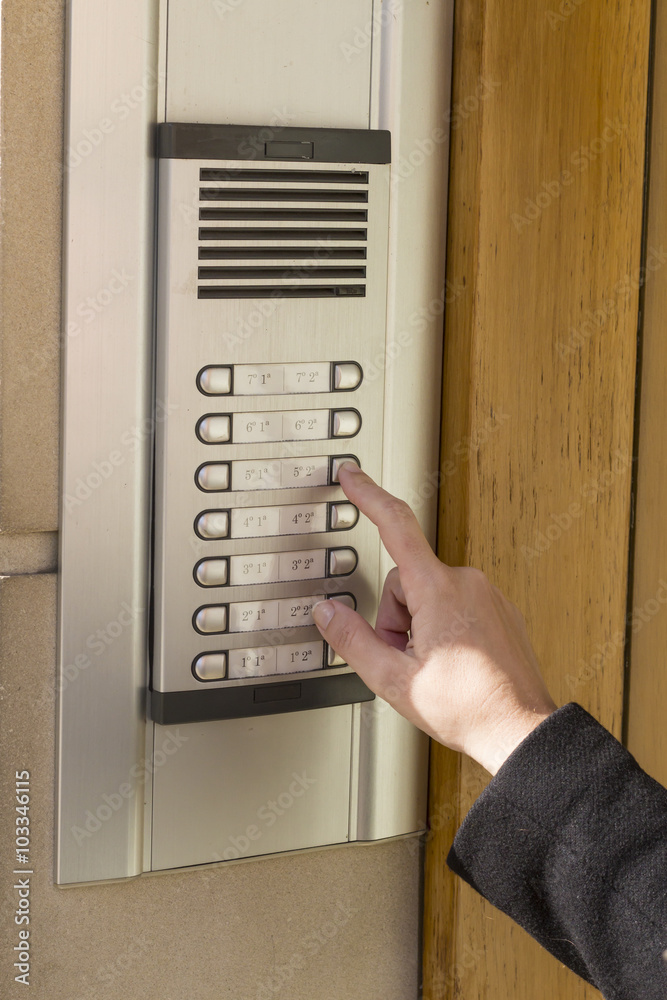Woman calling on the intercom Woman calling on the intercom