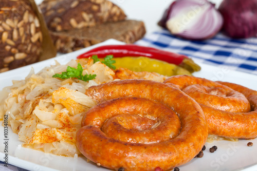 Bavarian fried sausages on sauerkraut © meteo021