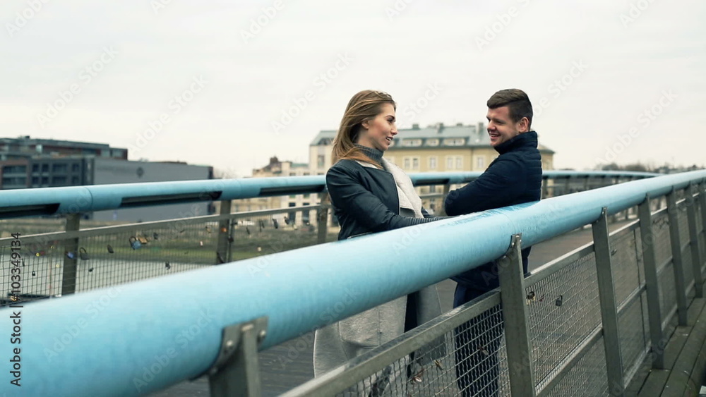 Young, happy couple talking on bridge in city
Young, happy couple talking on bridge in city
