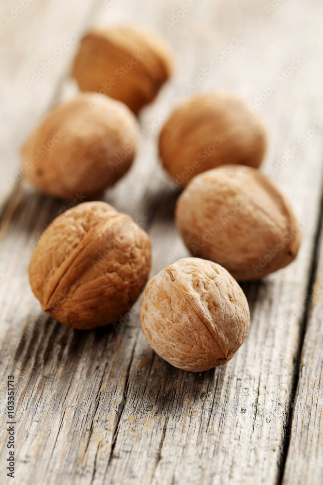 Walnuts on a grey wooden table Walnuts on a grey wooden table