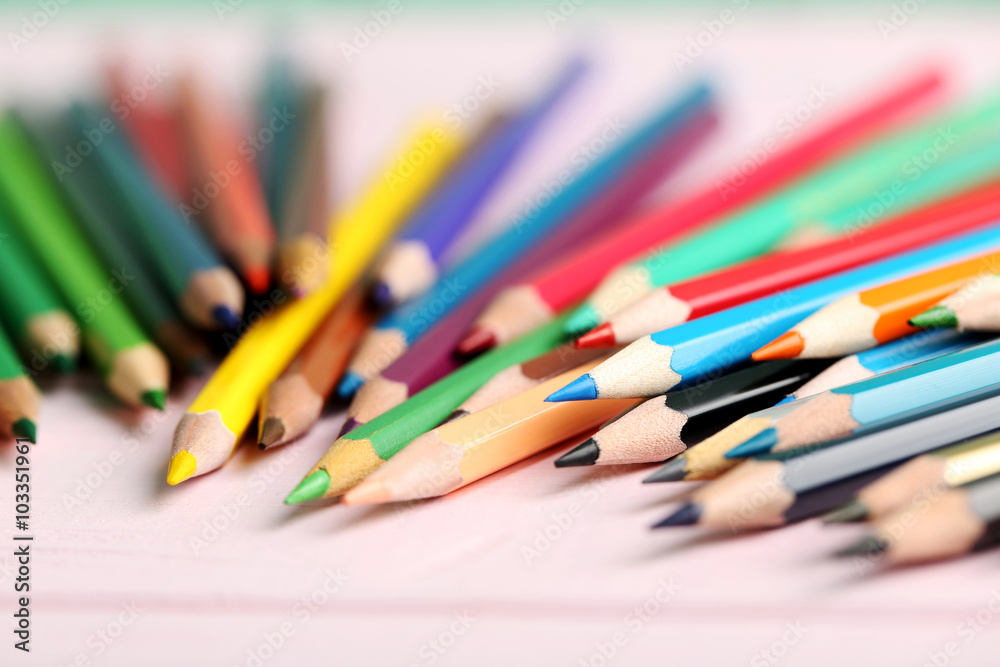 Drawing colourful pencils on a wooden background