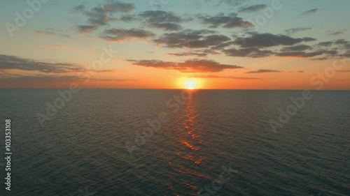 the sun sets over the horizon on the ocean