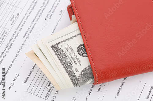 Money in Wallet on tax form background