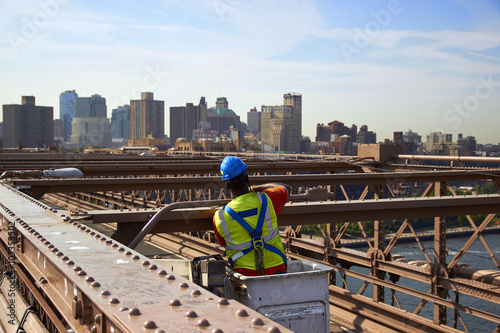 Worker on Brooklyn Bridge.