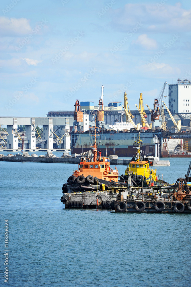 Fototapeta premium Tugboat and port cargo crane