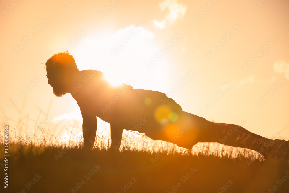 Male doing push ups in the park. 