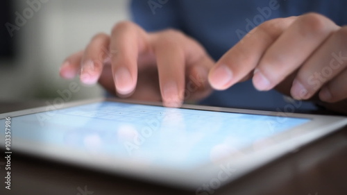 Hand touching screen on modern digital tablet pc.