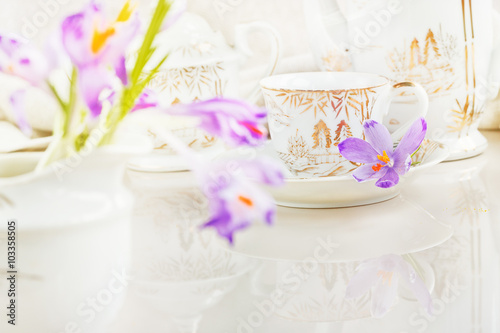 Cup of tea or coffee and crocus flowers