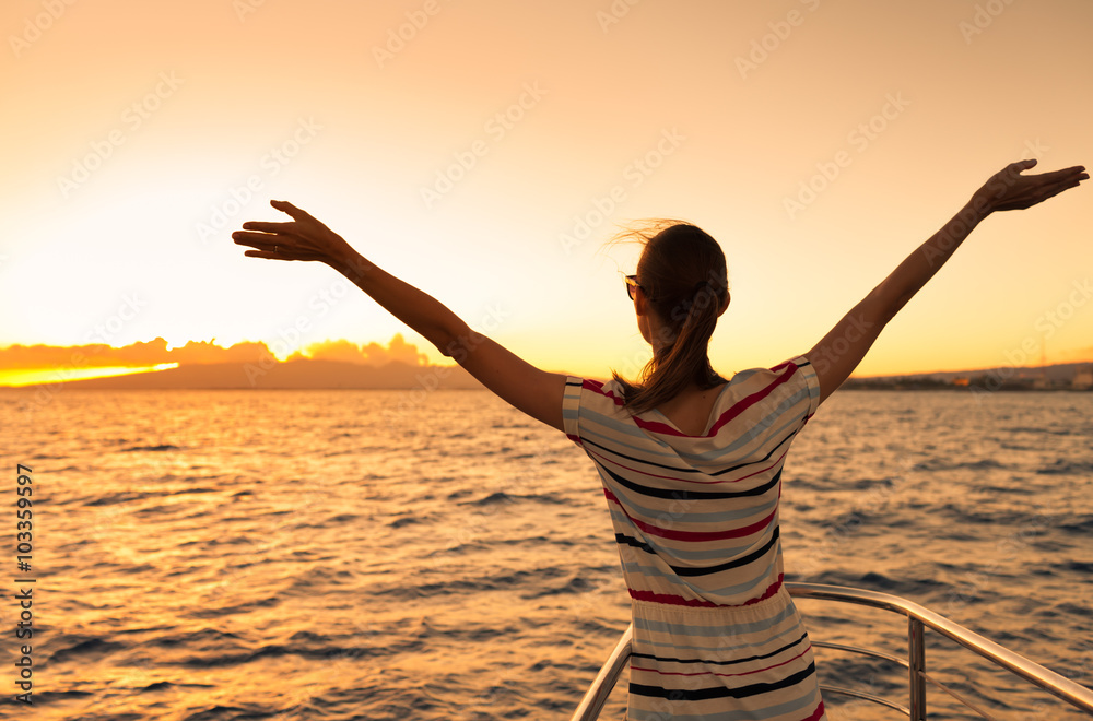 Woman on yacht enjoying the beautiful sunset.