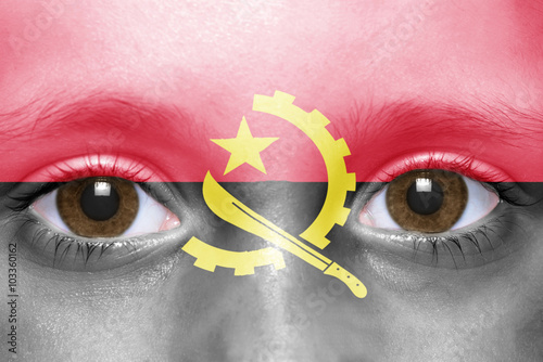 human's face with angolan flag photo