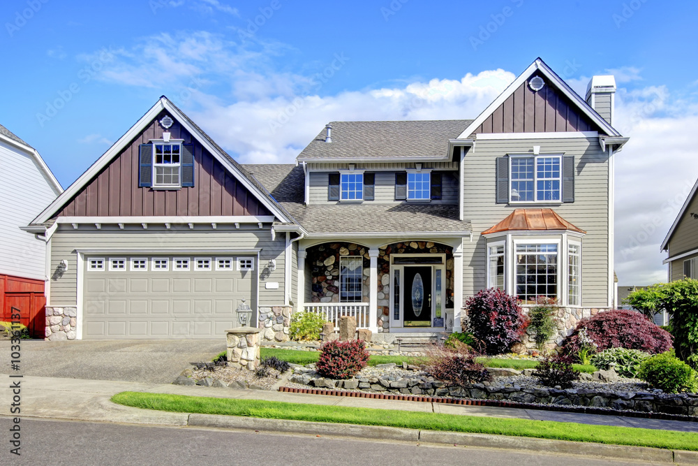 Modern home with navy blue door and decorative front yard. Modern home with navy blue door and decorative front yard.