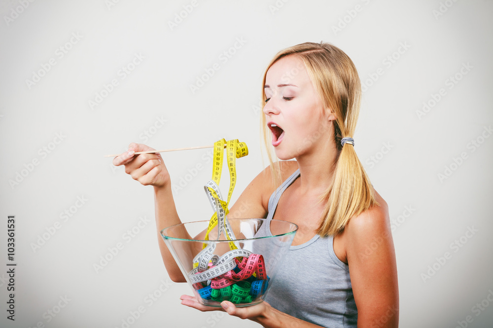 Diet. Girl with colorful measuring tapes in bowl Diet. Girl with colorful measuring tapes in bowl