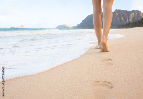 Woman walking on the beach in beautiful Hawaii. 