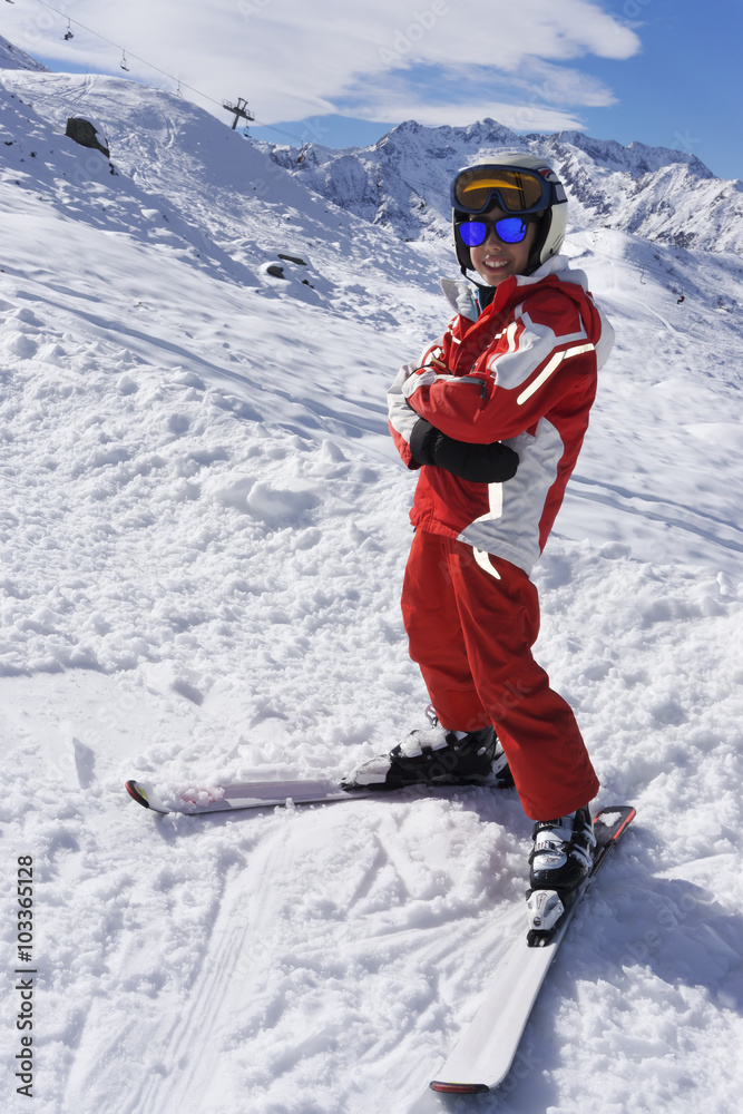 Smiling boy in ski suit on the slope