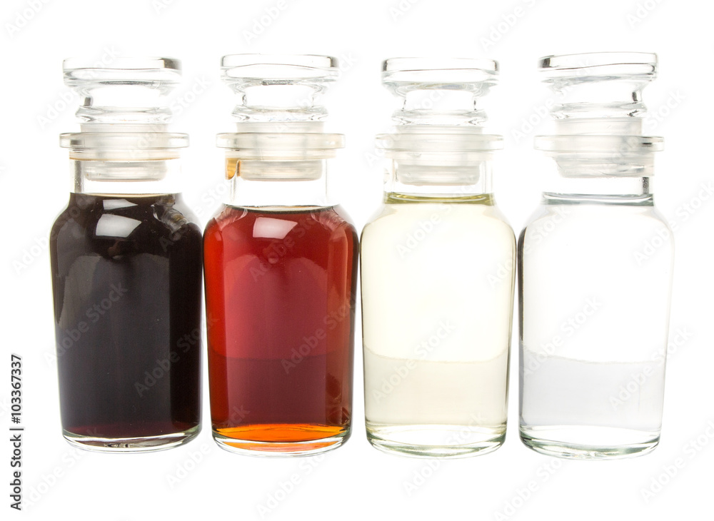 Vinegar, balsamic vinegar, maple vinegar and apple vinegar in glass vial over white background Vinegar, balsamic vinegar, maple vinegar and apple vinegar in glass vial over white background