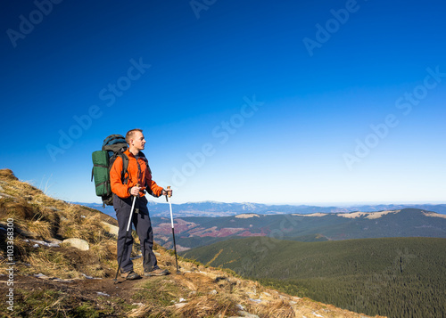 Hiker with Backpack in the wilderness on mountains