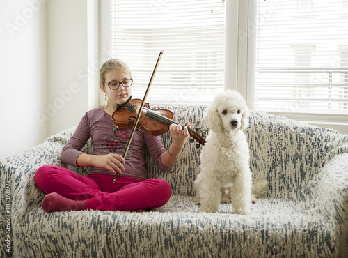 Girl vith volin and her dog photo