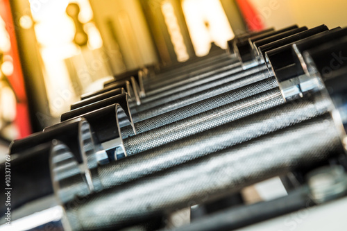Billede på lærred Dumbbells weight training equipment in gym close up