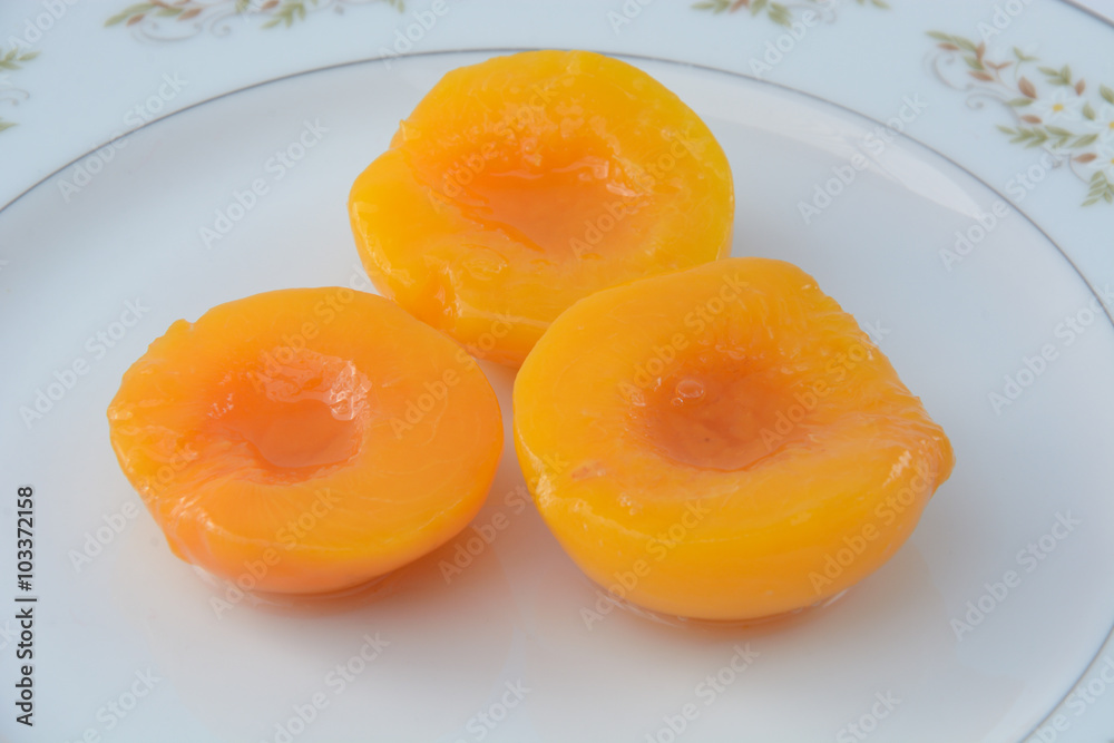 Canned peach halves on plate Canned peach halves on plate