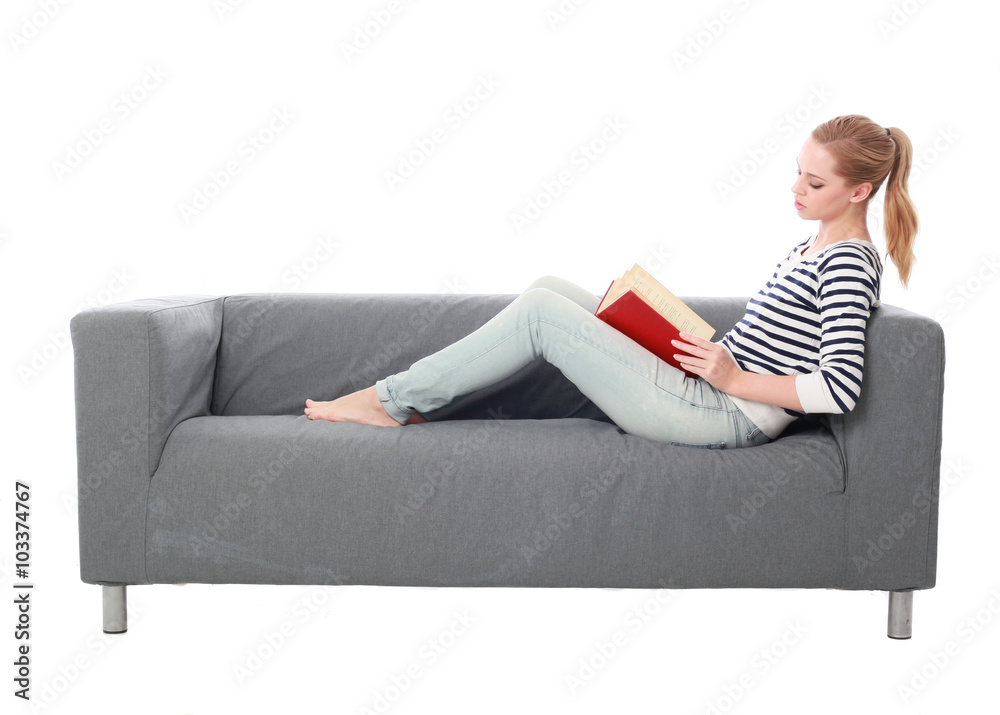 a pretty blonde lady wearing casual clothes, lounging on a grey sofa. isolated on a white background. a pretty blonde lady wearing casual clothes, lounging on a grey sofa. isolated on a white background.