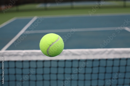 Tennis Ball Over Net on Blue Green Court © cpcthatsme