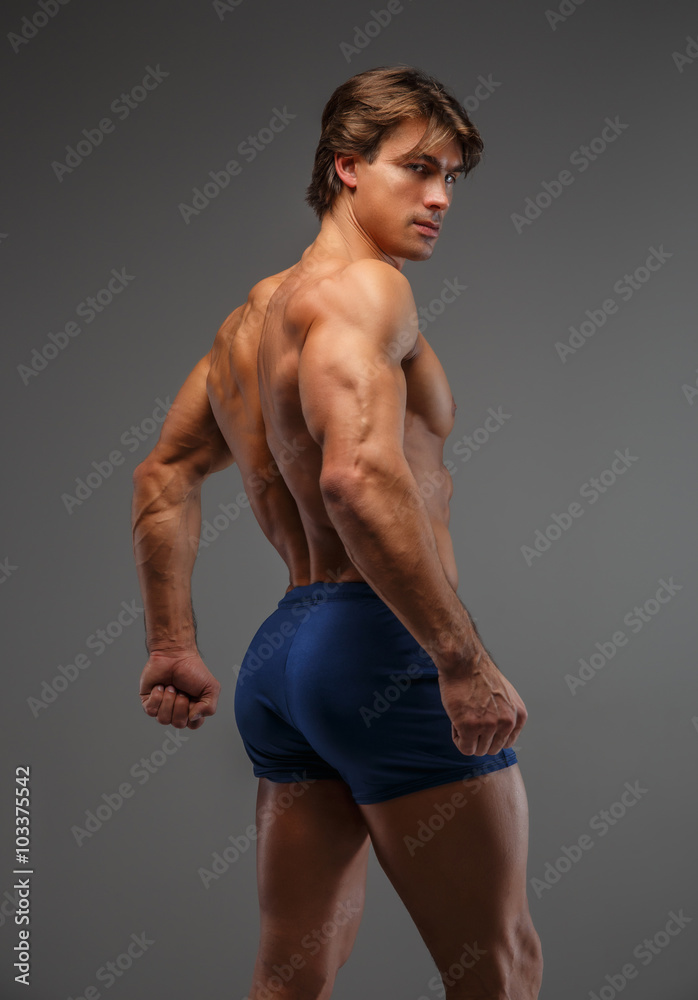 Shirtless muscular man in a blue shorts.