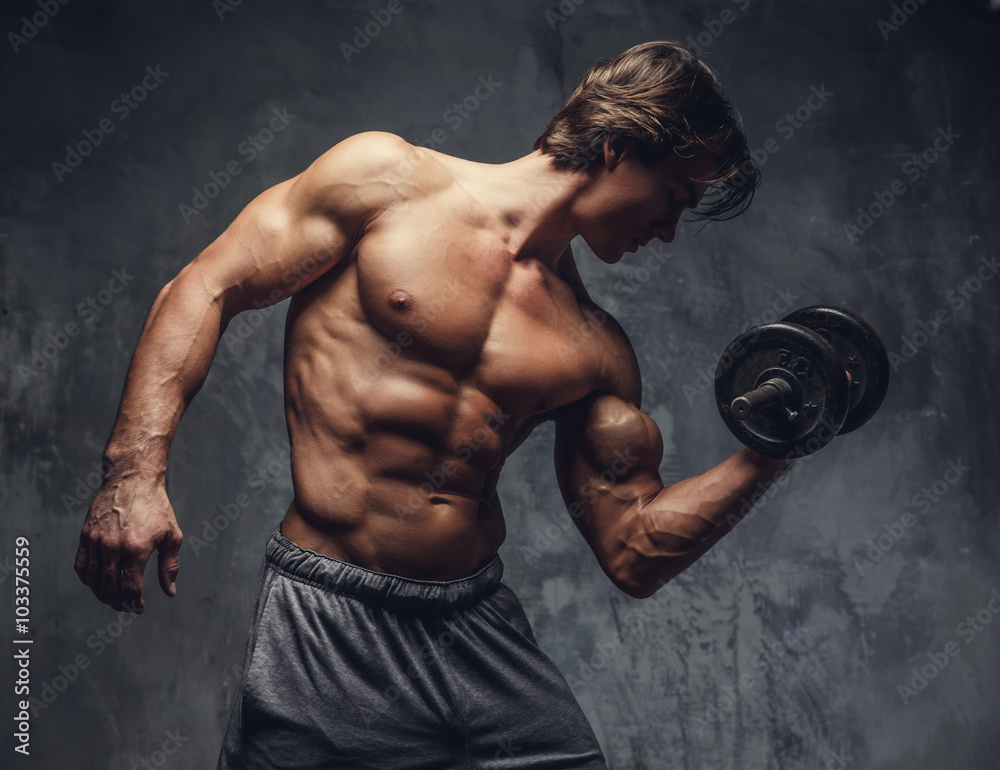 Shirtless muscular guy doing biceps exercise.