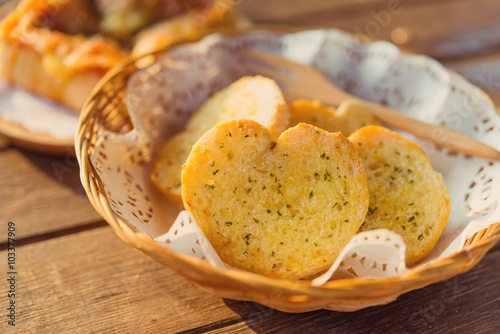 Garlic bread served in baskets on table