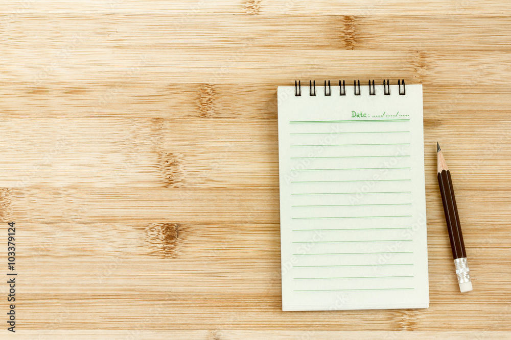 Blank notepad with pencil on wooden table Blank notepad with pencil on wooden table