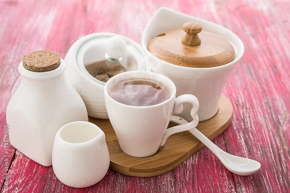 Tea cups with teapot on old wooden table Tea cups with teapot on old wooden table
