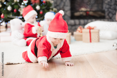 kids dressed as Santa Claus at Christmas tree with giftsImage ID:168340655