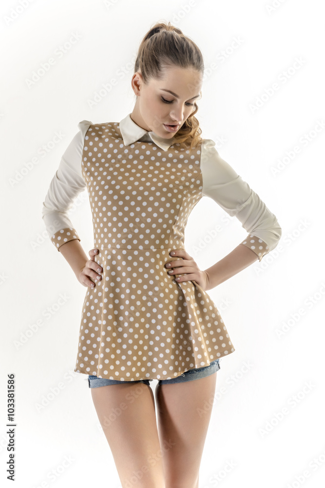 Beautiful blonde girl in a short vest and denim shorts
