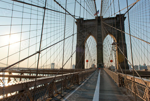 Fototapeta Naklejka Na Ścianę i Meble -  Iconic Brooklyn Bridge Path and Arches at Sunset