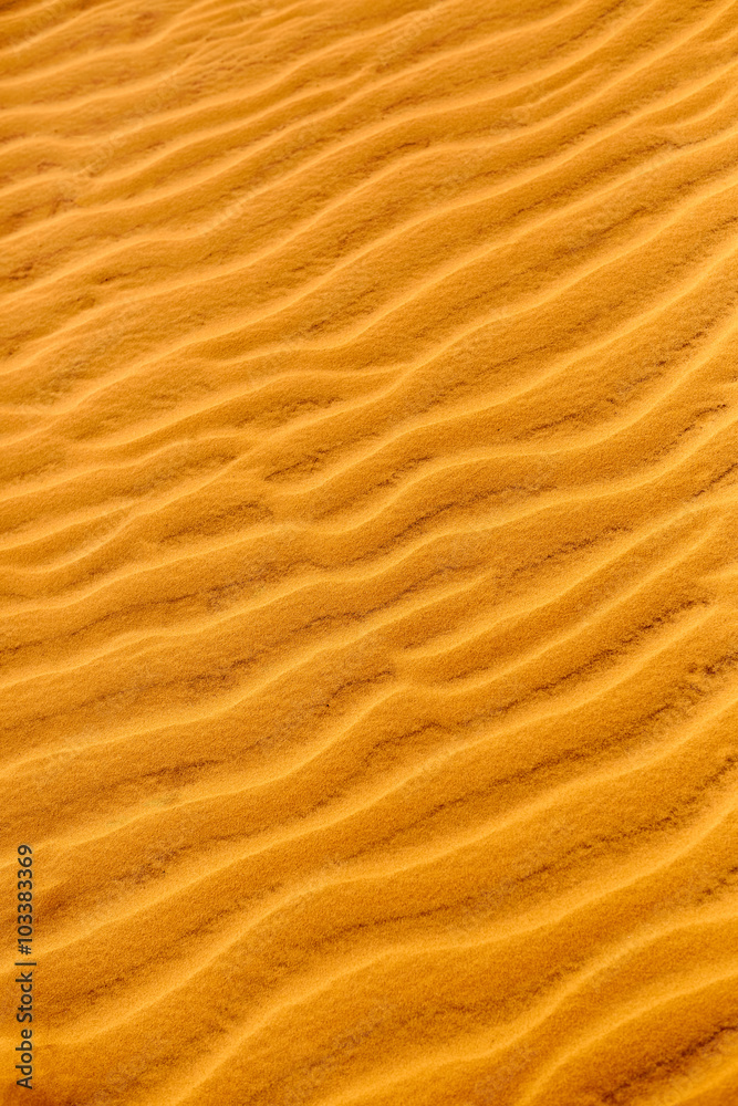 Sand Texture Background. Close up view of orange ripple sand pattern of dunes in desert. Nature elements details. Sand Texture Background. Close up view of orange ripple sand pattern of dunes in desert. Nature elements details.