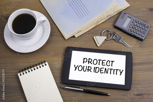 Protect Your Identity. Text on tablet device on a wooden table