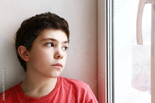 close up preteen boy portrait look at the window