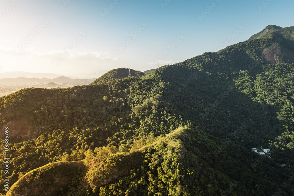 Green forest with mountains around the city aerial view, Brazil
