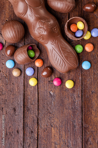 Photography Chocolate easter eggs and sweets on wooden background