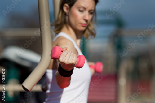 Girl exercising with dumbbells © Budimir Jevtic