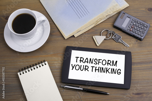 Transform Your Thinking. Text on tablet device on a wooden table